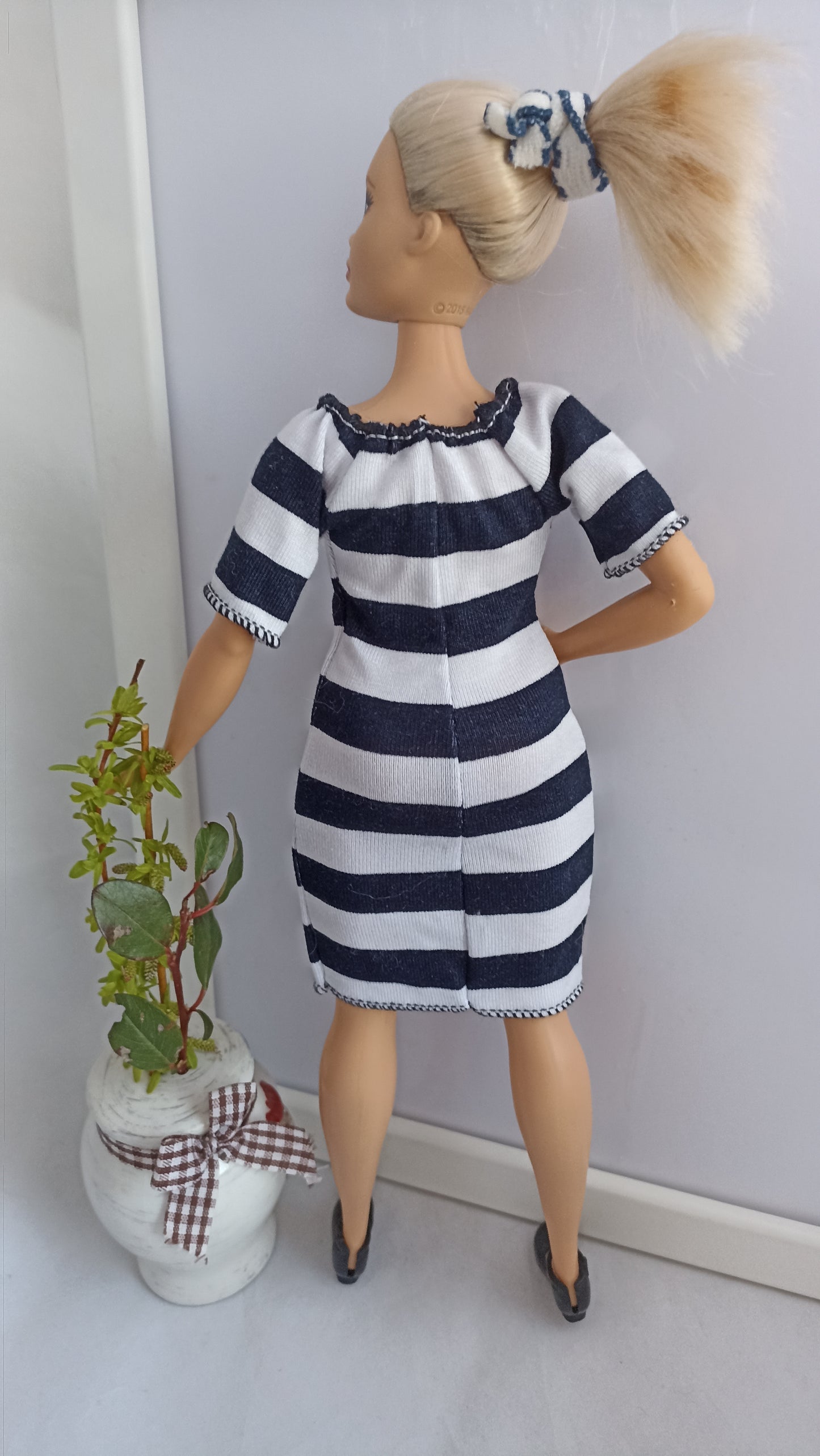 Curvy doll in white and black stripes dress, stretch.